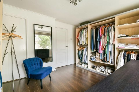 A well-organized modern wardrobe showcasing a variety of clothing and accessories, complemented by