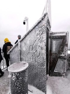 Snowy and icy spire from the Asenturm am Ochsenkopf with people, conveys an icy atmosphere, hiking