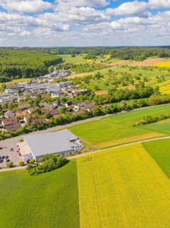 Farm village surrounded by green and yellow fields under a cloudy sky, Gechingen, Black Forest,