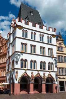 White historic building with red decorations and medieval charm in the city, Haus Steipe with