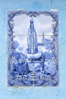 Tile with a religious motif in a house wall, Burano, Veneto, Italy