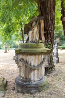 Old grave figure on a column, without head, Riesa cemetery, Saxony, Germany