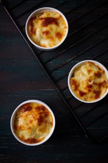 Julienne with mushrooms and cheese, in white ceramic cups, homemade, top view, no people