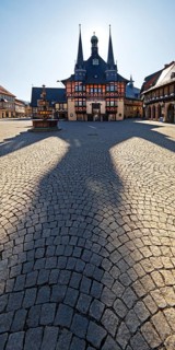 Market square with town hall and long shadow in the backlight, Wernigerode, Harz, Saxony-Anhalt,