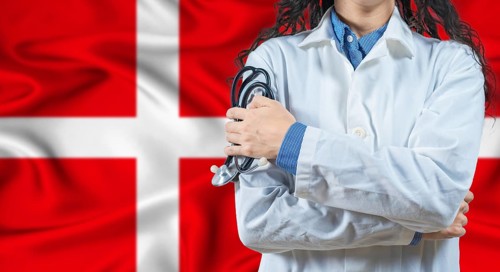 Healthcare professional with Denmark flag background. Professional doctor holding stethoscope on