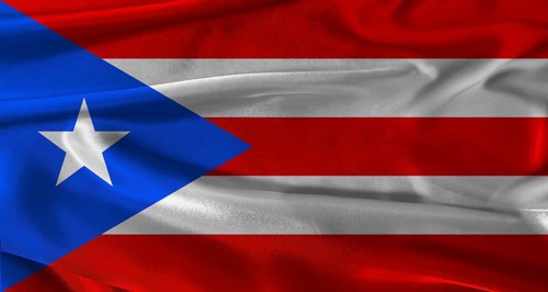 Flag of Puerto Rico with fabric textured background. Close up of National flag of Puerto Rico with