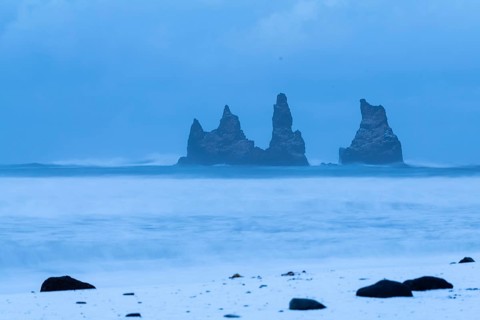 Reynisdrangar pinnacles, lava sandy beach, waves, sea, clouds, snow, winter, Vik, Iceland,
