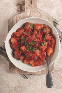 Stew with potatoes and vegetables, in tomato sauce, with spices and herbs, close-up, homemade, no