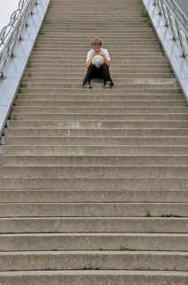 Lonely ten-year-old boy with his football, stairs to the viewing platform of the Chocolate Museum,
