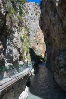 Narrow gorge with steep rock walls and a walkway over a flowing river, Saklikent Gorge, Saklikent