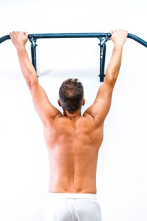 Muscles of the patient doing a dominated without a shirt. Reopening with security measures of