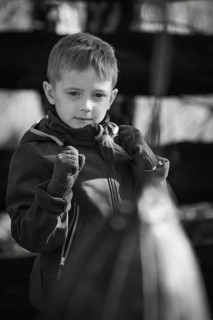 Portrait of a boy practicing boxing outdoor.