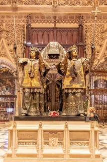 Two ornate royal statues in a Gothic church as part of a tomb, Seville
