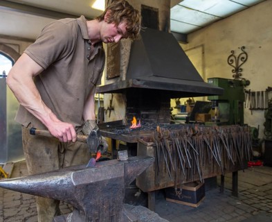 A blacksmith forging, working at the Ehnert forge in Dresden-Bühlau, Saxony, Germany