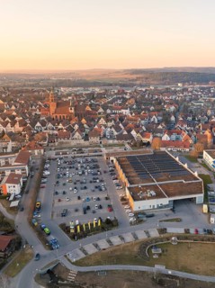 Town view with many white roofs, church tower and a car park in the evening light, Weil der Stadt,