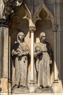 Mary and Martha as large figures at the entrance to St James' Church, Freiberg, Saxony, Germany