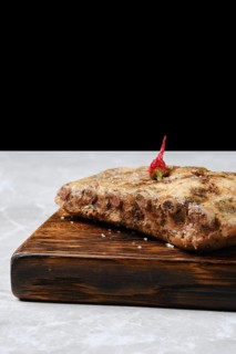 Close-up view of baked spicy pork ribs on a rustic wooden board