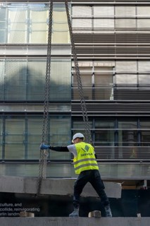 Loading concrete slabs onto a truck trailer using a construction crane, Berlin, Germany