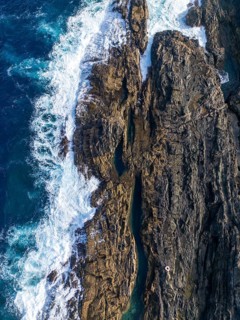 From above, captured by a drone, this image showcases the rugged beauty of Tindaya Beach in