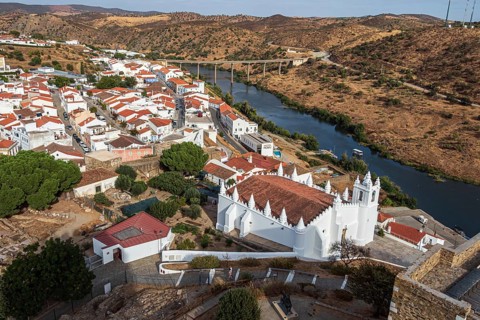 View from the castle of Mertola, white houses of the small town, slopes along the Rio Guadiana