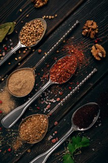 Georgian spices in spoons, on a wooden background, top view, no people