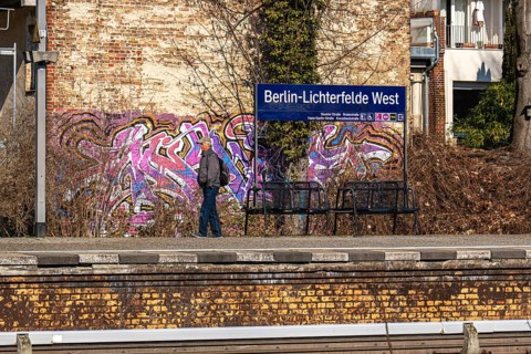 S-Bahn platform with passengers and historic structures at Lichterfelde West railway station,
