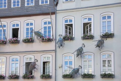 Grimm-Dich Trail, The Brave Little Tailor with 7 Flies, House Façade with Oversized Insect Figures