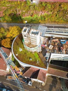 Aerial view of a construction site with concrete tower, construction site material and surrounding