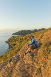 Couple watching island view at sunset, Drawaqa Island, Yasawa island group, Fiji