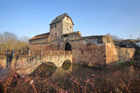 Medieval moated castle built in 12th century with stone arch bridge and pond, Bad Vilbel, Wetterau,