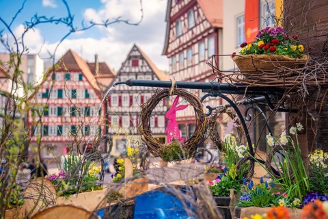 Colourful Easter decorations in front of half-timbered houses surrounded by flowers, Calw, Black