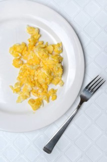 Scrambled eggs on a plate and fork