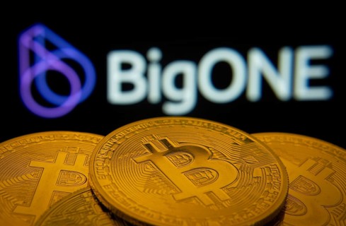 Dhaka, Bangladesh- 15 June 2025: Close-up of Bitcoin coins with the bigONE logo visible on a screen