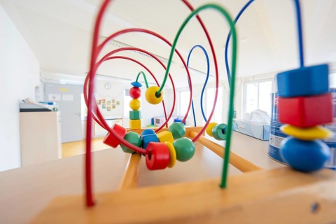 Wooden toy with colorful motor skills loops in a bright children's room, children's house, Calw,