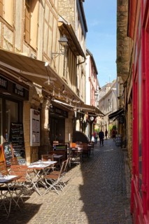 Restaurants and shops in the narrow, cobbled Rue des Halles in the old town of Vannes, Brittany.