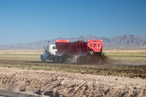 Buckeye, Arizona - Fresh soil is spread on a farm in the Arizona desert