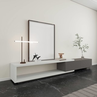 A minimalist interior scene featuring a sleek console table against a neutral wall. It holds a