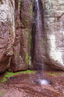 Fairy grotto with waterfall at the Dragon Gorge in Eisenach, Thuringia, Germany