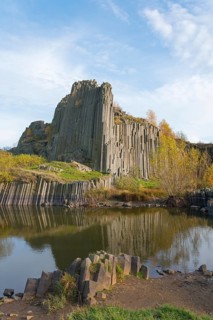 A charming landscape with basalt columns and calm water in an autumn scene, manor rocks, Panska