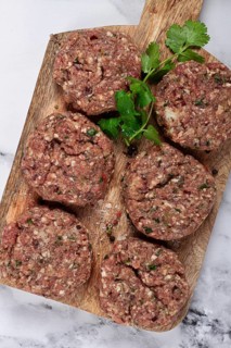 Raw cutlets, minced meat, on a chopping board, homemade, top view, no people