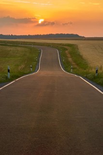 Winding country road at dusk, in midsummer, Marktheidenfeld, Main Spessart, Bavaria, Germany