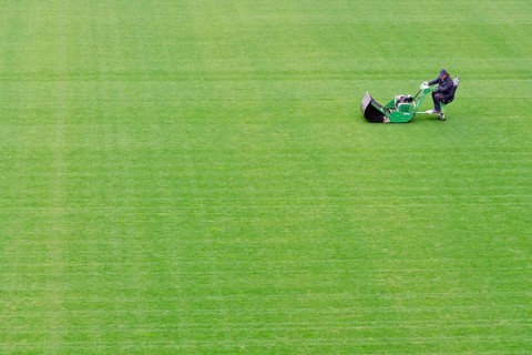 Mowing grass at the football pitch in Lubin, Poland