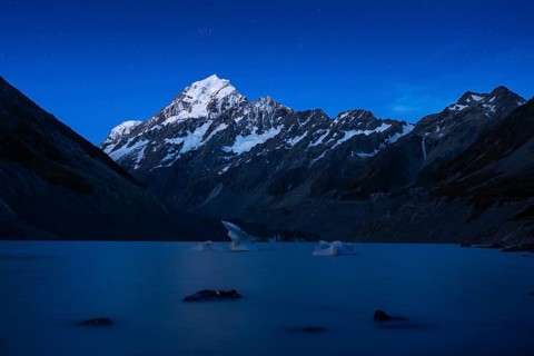 Mountainous landscape. Hooker Lake and Aoraki Mount Cook. Evening atmosphere, blue hour, first