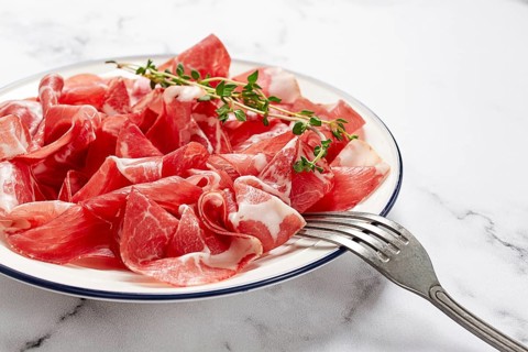 Plate with sliced cured meat, pork neck, prosciutto coppa, Italian delicacy