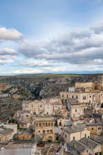 Captivating view of Matera's historic stone buildings blending with the rugged surrounding
