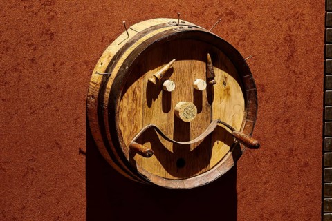 Creative wooden barrel wall art depicting a smiling face, Achaia Clauss Winery, Patras,
