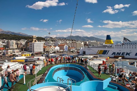 People on a ferry with a view of the port and the city behind it, Old Ferry Port in the center of