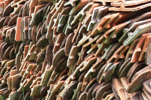 Old roof tiles stored on stockpiles for reuse on historic buildings and heritage-protected houses,