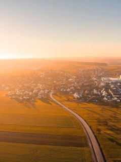 Aerial view of a village with fields at sunset, warm colours, Obergaugstett, district of Calw,