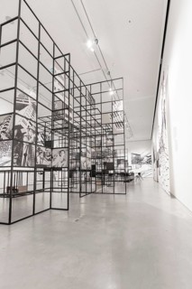 Modern art gallery with grid structures and black and white decorations that create an industrial